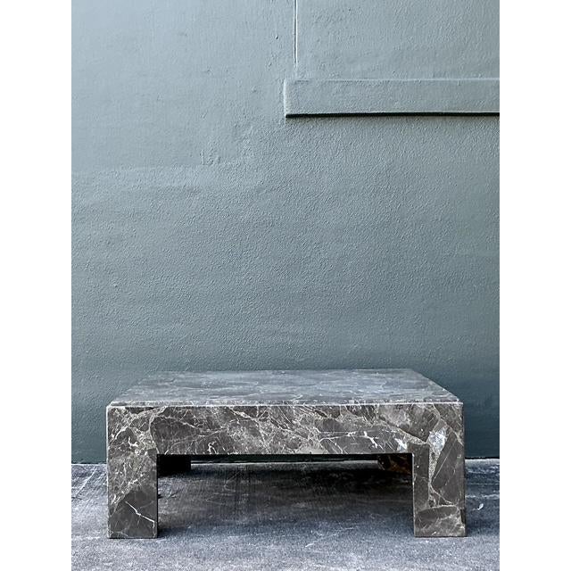 This striking coffee table is a masterclass in Postmodern minimalism, showcasing the opulent beauty of genuine Emperador...