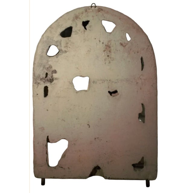 Antique arched wall plaque depicting cherub wine harvest imagery with classical detailing. A charming decorative accent...