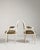 A refined pair of Louis XVI armchairs characterized by clean, straight lines and neoclassical symmetry. The upholstered...