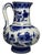 A hand-painted royal delft pitcher vase by de porceleyne fles. The piece has a rounded lower body, a tall cylindrical...