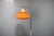 Striking vintage Hungarian floor lamp dating from the 1970s, featuring a sculptural orange plastic shade with a...