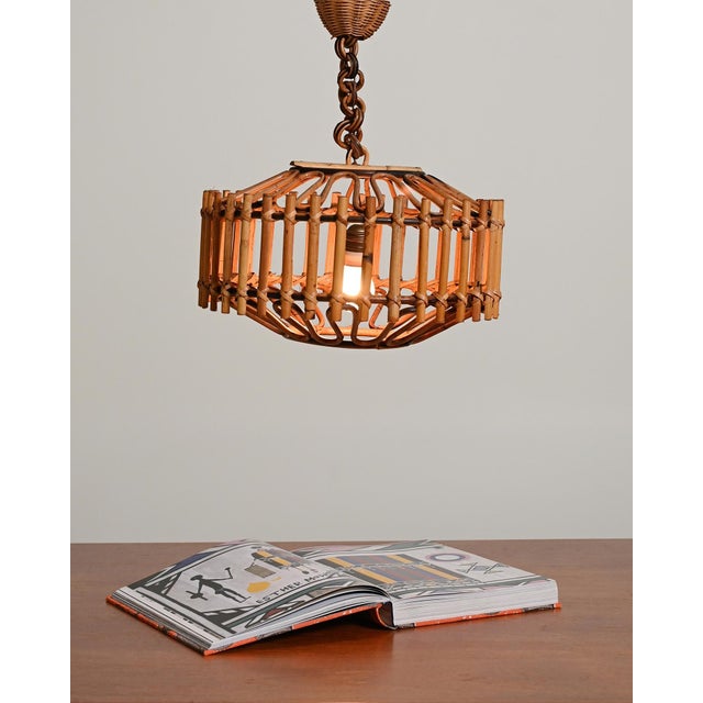 Hand-woven bamboo pendant lamp with a cylindrical frame and rattan chain. 75 cm long electrical cord. 1970s. Woven rattan...