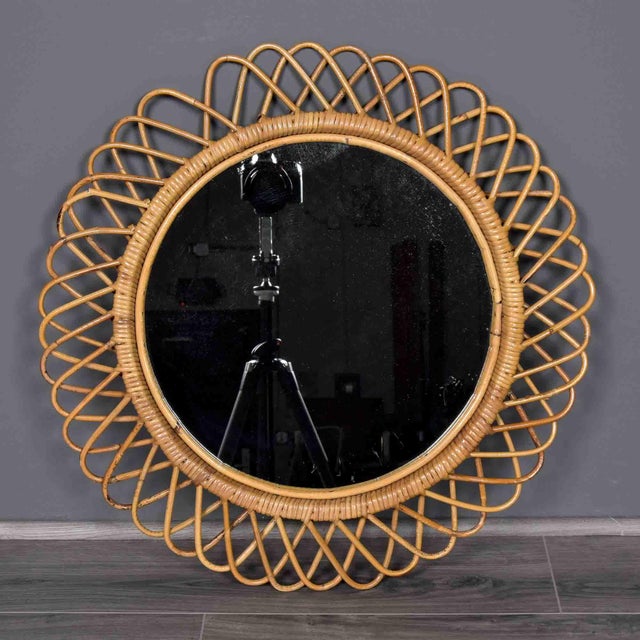 This Italian wall mirror from the 1950s showcases the artisanal rattan work that defined Mediterranean modernism. The...