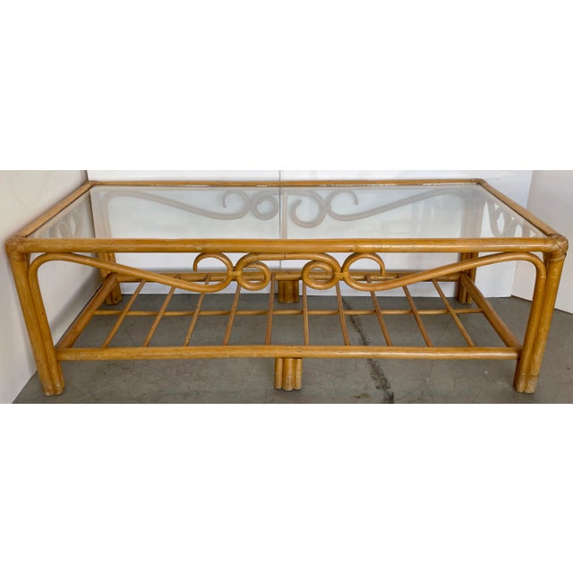Elegant Thonet style coffee table from 60's. Made of bent bamboo and newly replaced glass top. Wear on bamboo finish. No...