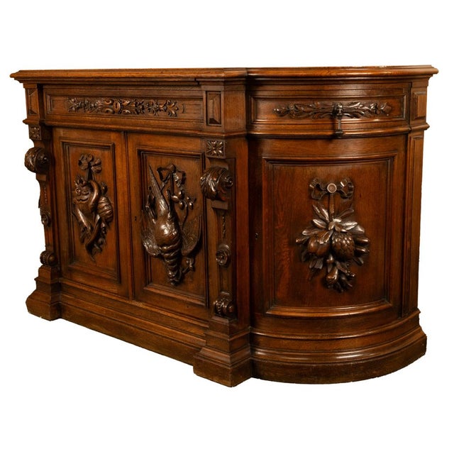An exceptional antique French carved oak 'Hunt' buffet. bar, sideboard in the Black Forest style, circa 1870. The break-...