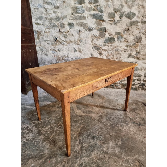 This antique French table dates from around 1900 and combines the functionality of a dining table and a writing desk. The...