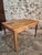 This antique French table dates from around 1900 and combines the functionality of a dining table and a writing desk. The...