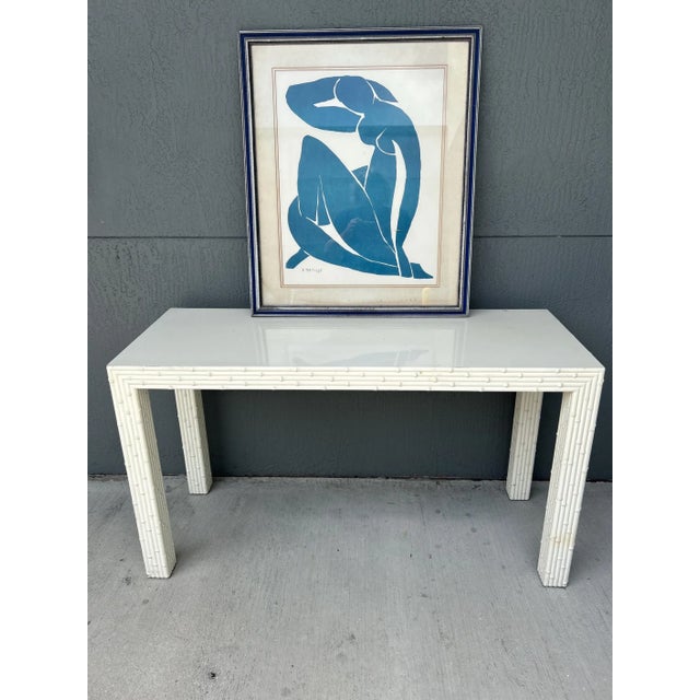 This is a high quality solid wood faux bamboo console. The legs and the border is faux bamboo. The finish can be used with...