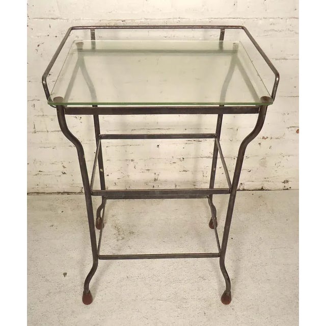 Metal table with glass top. Refinished in a bare metal style finish.