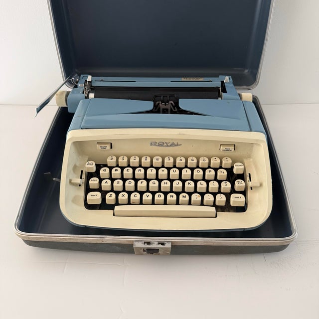A striking example of mid-century office design, this vintage Royal Aristocrat portable typewriter features a powder blue...