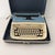 A striking example of mid-century office design, this vintage Royal Aristocrat portable typewriter features a powder blue...