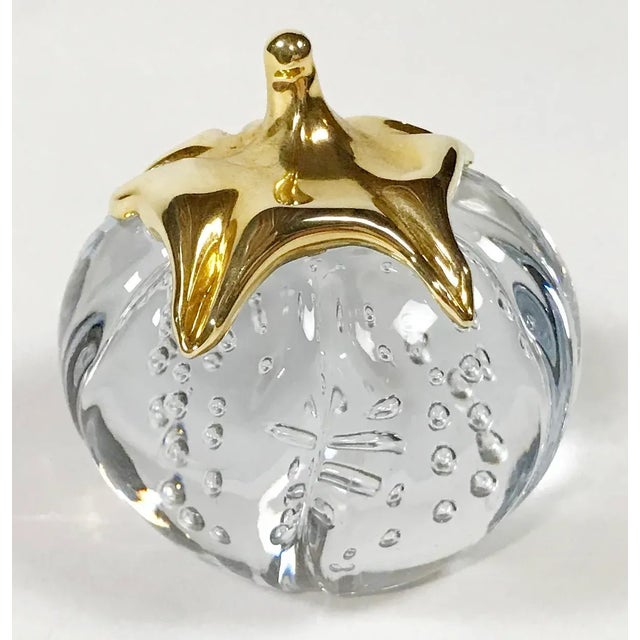 Vintage clear crystal glass paper weight in the shape of a pumpkin. Brass stem. Patina to brass. Free of chips or cracks...