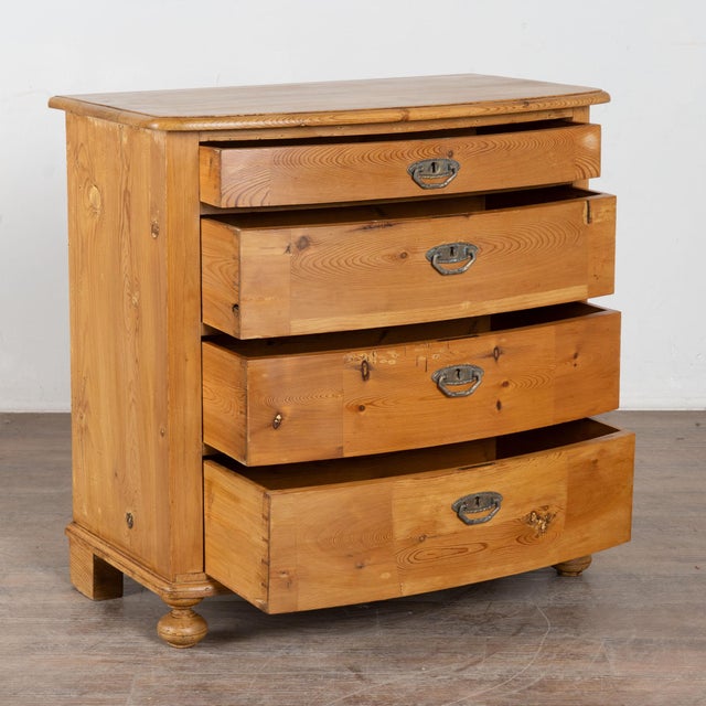 The gentle bow front of this 4-drawer chest adds to the simple grace of the piece. It has been given a waxed finish,...