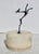 Carved in alabaster with a decorative lotus band around the base of the walls. The top handle is a chromed figure of a...