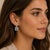 18k White Gold Diamond and Sapphire Earrings Earrings featuring round white diamonds and square blue sapphires. Crafted in...