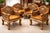 An intricately carved seating group made of solid teak, consisting of four armchairs and a matching coffee table. Balinese...