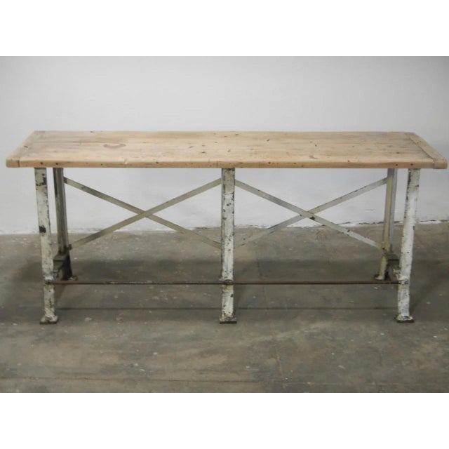 This industrial bench with cast iron legs and a natural beech top was made in France during the 1920s.