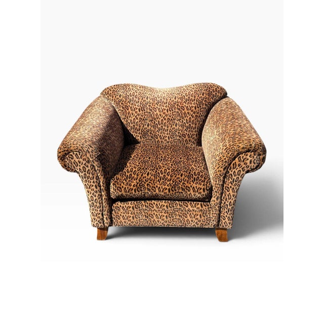 A big, unapologetic statement chair upholstered in leopard print velvet. At four feet wide it reads more like a chair-and-...