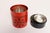 Set of three metal nesting canisters with red craclequer-style litho exterior and black floral snowflake motif (ca. 1960s,...