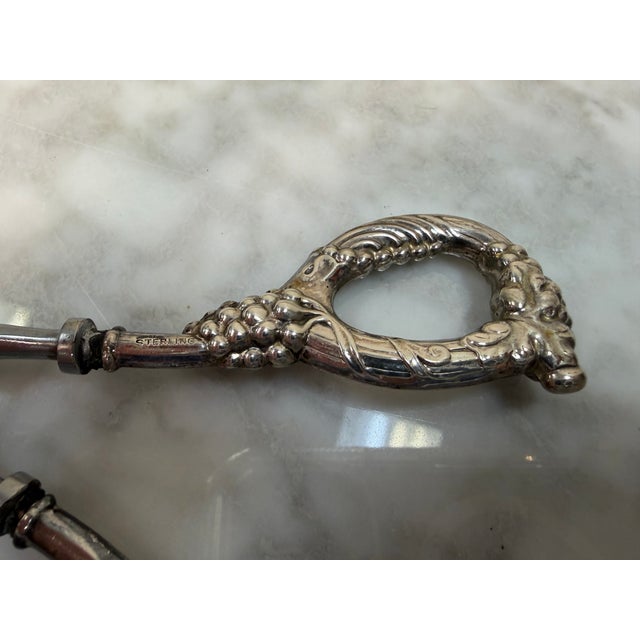 Elevate your tabletop or bar presentation with this exquisite pair of vintage mid-century grape shears from famed luxury...