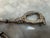 Elevate your tabletop or bar presentation with this exquisite pair of vintage mid-century grape shears from famed luxury...