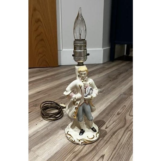 Adorable, small, vintage porcelain figural table lamp depicting an 18th-century French courtier or colonial gentleman....
