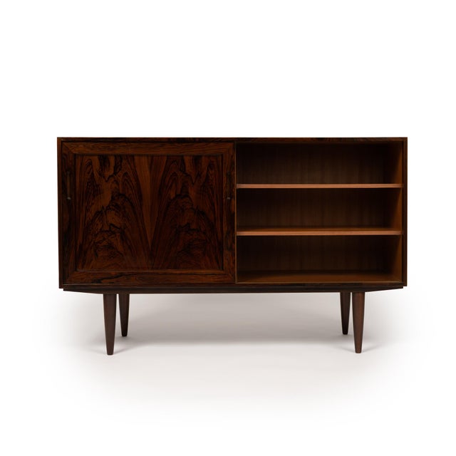 This stunning Danish Mid-Century credenza showcases the unparalleled beauty of richly grained rosewood, exuding timeless...