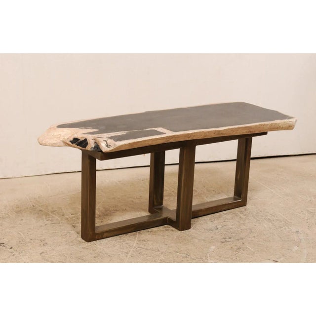 A petrified wood top modernly designed coffee table (or bench). This custom coffee table has been fashioned from a...