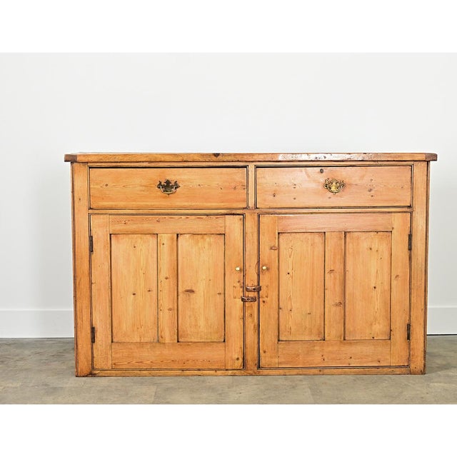 A gorgeous pine buffet from 19th century England, the restrained construction highlights the glowing effect of the blonde...