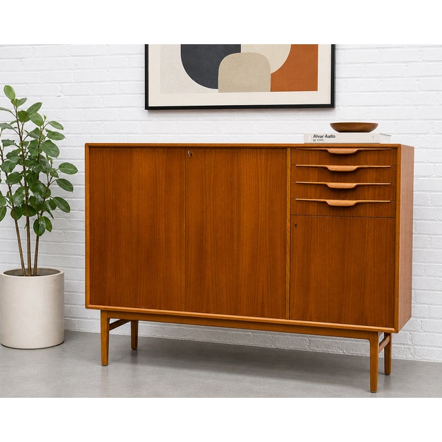 Vintage Mid Century Modern teak highboard credenza designed by Beril Fridhagen for Bodafors in Sweden, c. 1960s. A true...