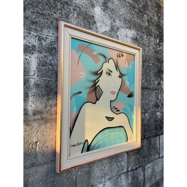 Post Modern Framed Oil Painting in the Patrick Nagel Style. Circa 1980s Features a portrait of a female model painted in...