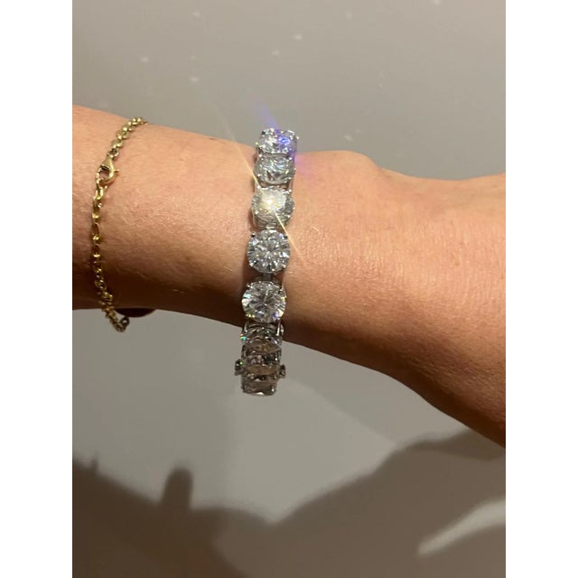A Synthetic Moissanite Line Bracelet, with 17 round synthetic Moissanites claw set in sterling silver. 17 x 5ct RBC...