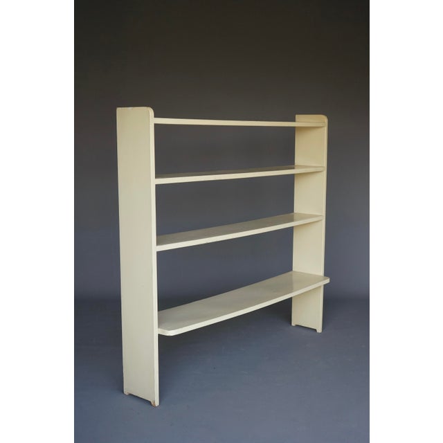 This simple modernist wall mounted shelving unit would be best attached to a wall using the two fittings to the reverse...
