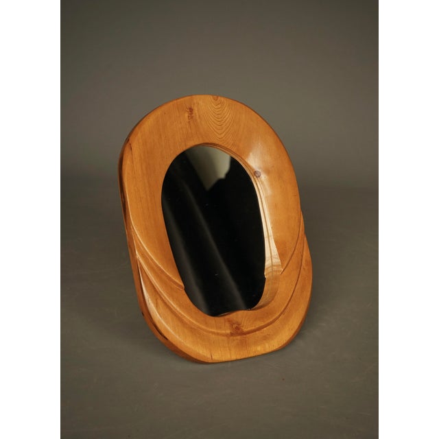 A small Anthroposophical oval formed pine mirror.
