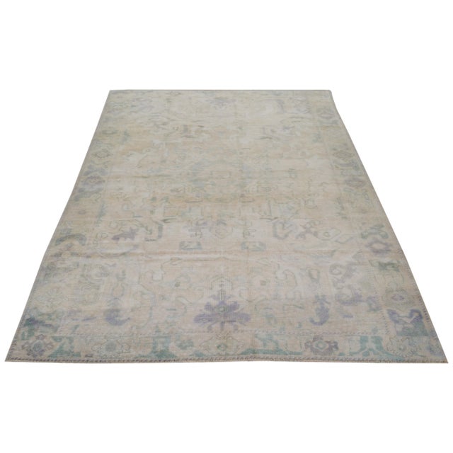 Vintage Turkish Oushak Hand-knotted with care using traditional rug-making techniques, this wool rug blends timeless...