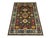 This Kazak-style tribal area rug pairs a rich brown field with a vivid teal border. A central star medallion is surrounded...