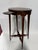 A refined Edwardian inlaid tea table of elegant small scale, designed with an oval top, single pull slide shelf, shaped...
