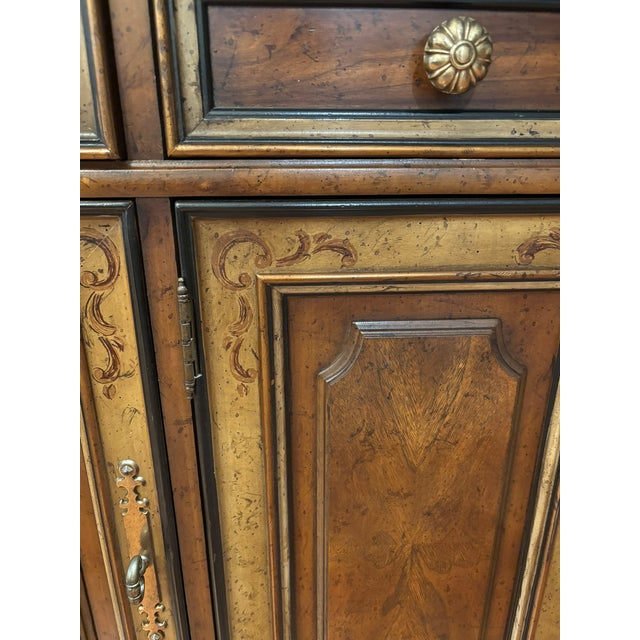 Crafted from walnut with beautiful brass accents and unique paint-decorated cabinet doors, this Renaissance, Tuscan-...