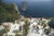 Il Canille 1980 Sunbathers lounge on the white-painted terrace of Il Canille, built into the rocks of Pizzolungo...