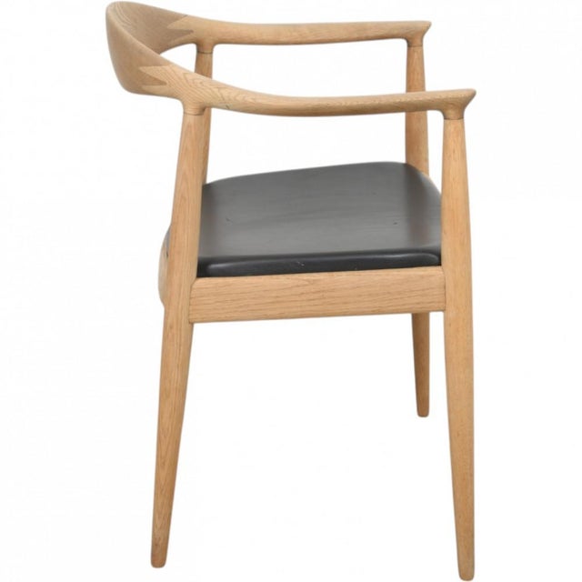 Hans Wegner The Chair, model JH503, with a frame of oak and a seat upholstered in black leather. The chair is from the...