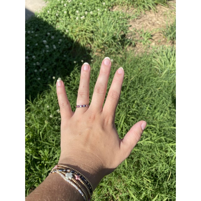 Stones: ruby, 15 round cut 1.75 mm approximately .45 total carats diamond, 15 round brilliant cut 1.75 mm approximately...