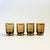 A set of 4 beautiful mid century glass cordials. Smokey gray color to the glass with a metallic gold grid design. Each...