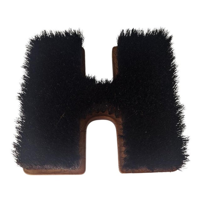 This is a Carl Auböck wooden clothes brush, probably from the 1960s, often designed in the shape of letters. The brush is...
