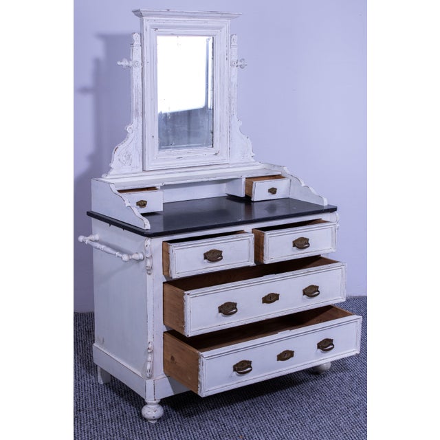 Antique pine dresser with a vintage, rustic charm. Featuring a large mirror, multiple drawers with brass handles, and a...