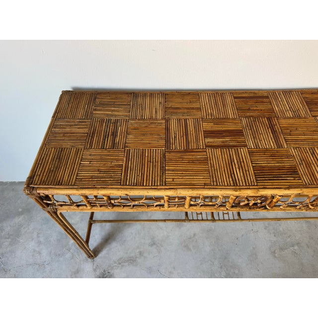 A beautifully crafted vintage bamboo console table in the Chinese Chippendale style, featuring intricate fretwork...