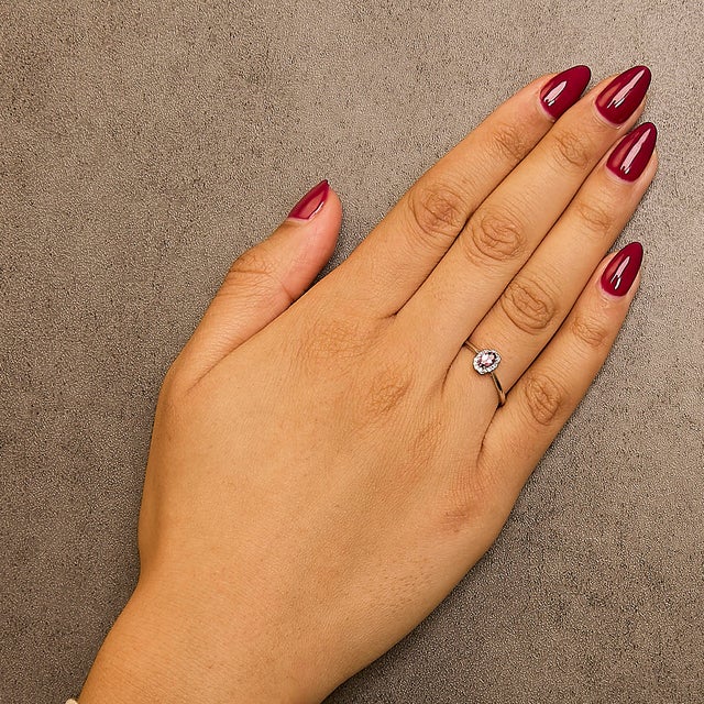 Elegant and radiant, this exquisite ring is a symphony of color and light, masterfully crafted from rhodium-plated 10K...