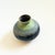 A vintage mid century pottery vase with a textured lava glaze. Blue, light green, tan, and brown glazes. No marking on the...
