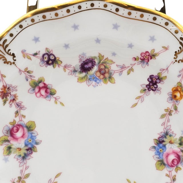 A delicate study in refinement, this Royal Crown Derby bread plate embodies the lightness and grace of English bone china....