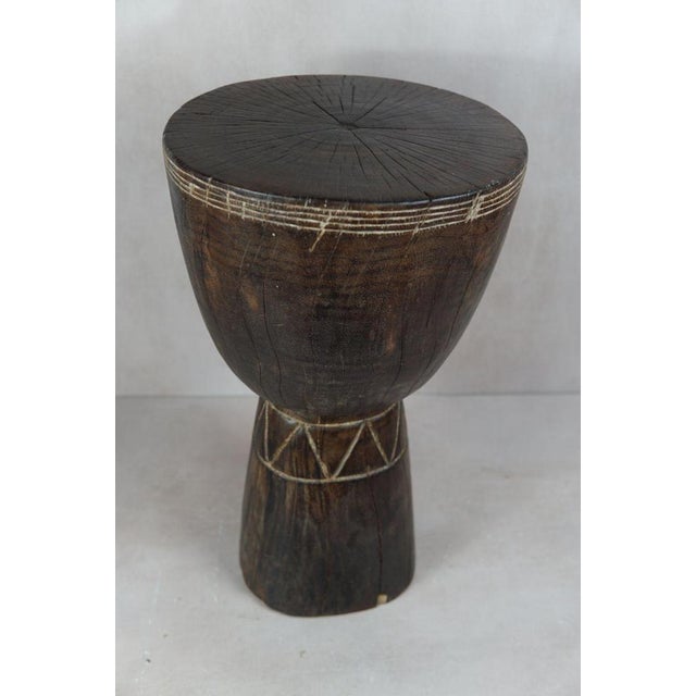 Introduce a touch of African elegance into your living space with this remarkable solid wood carved side tablestool from...