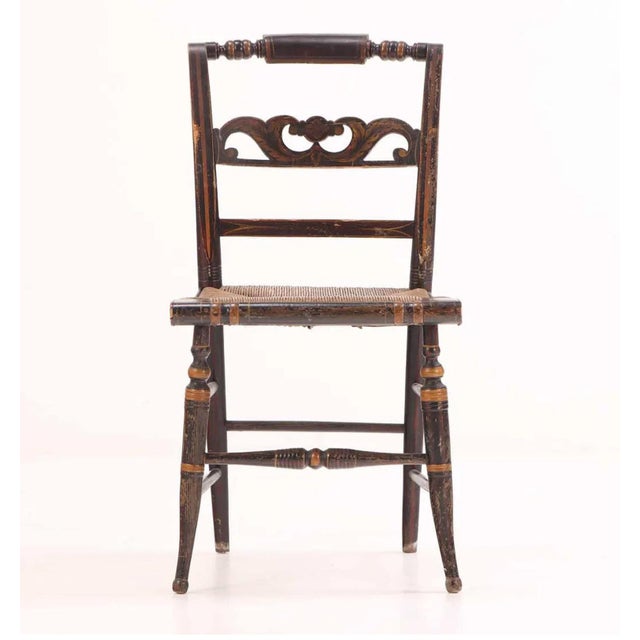 A beautifully assembled set of ten Hitchcock dining chairs, crafted in ebonized hardwood with handwoven rush seats and the...